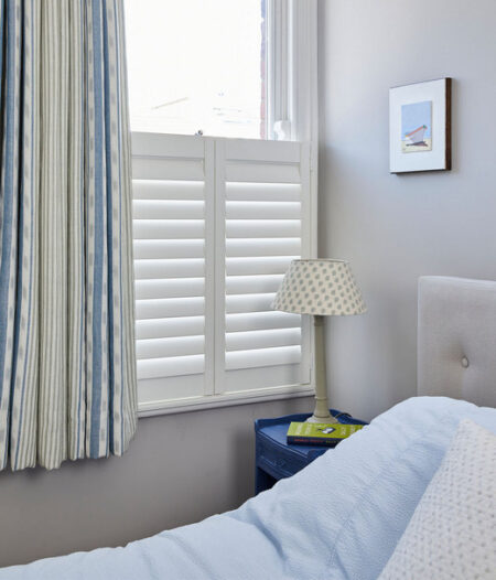 cafe style shutters in a bedroom