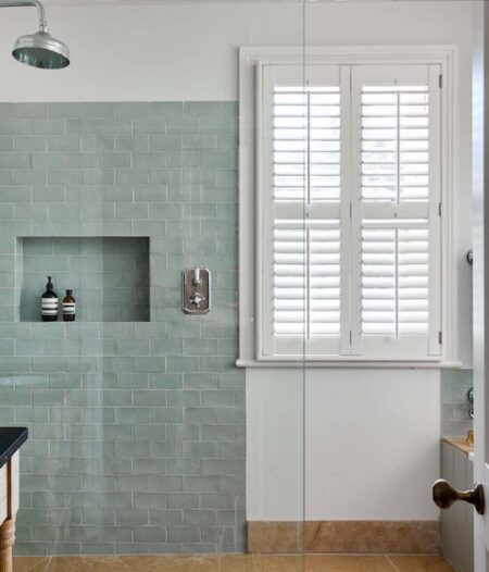 shower room with grey tiles and white waterproof shutters on the window