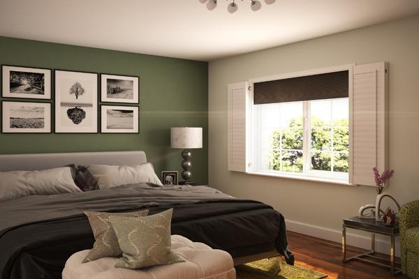 image shows a modern bedroom with a window dressed with darkening honeycomb blinds and shutters, to ensure maximum darkness when they are both closed